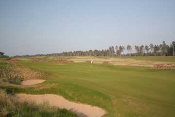 The 11th green is very narrow at the Renaissance Club, and features bunkers left and a stone wall right (B. Tucker)